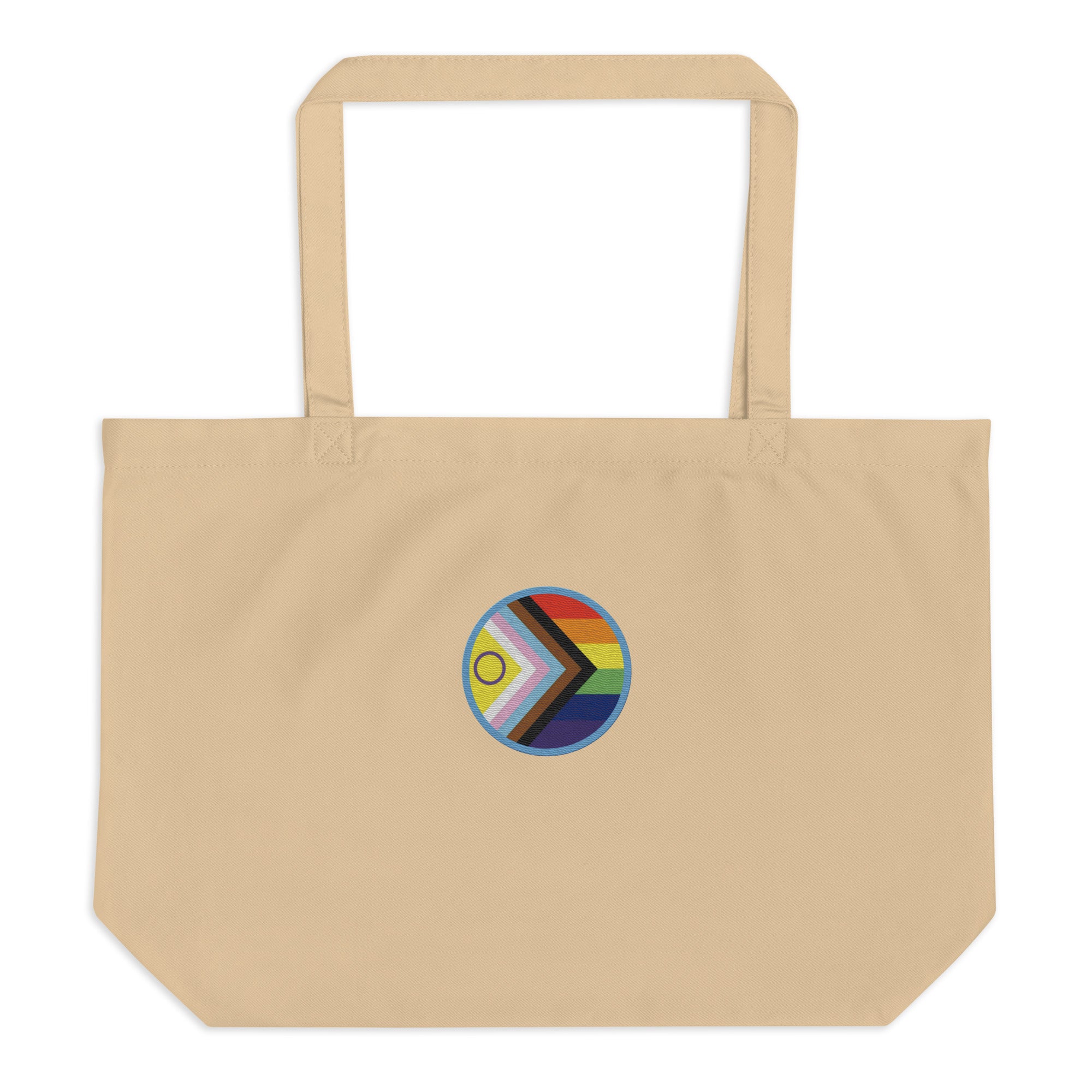A beige canvas tote bag with two top handles, featuring a circular Progress Pride flag graphic printed on the front center.